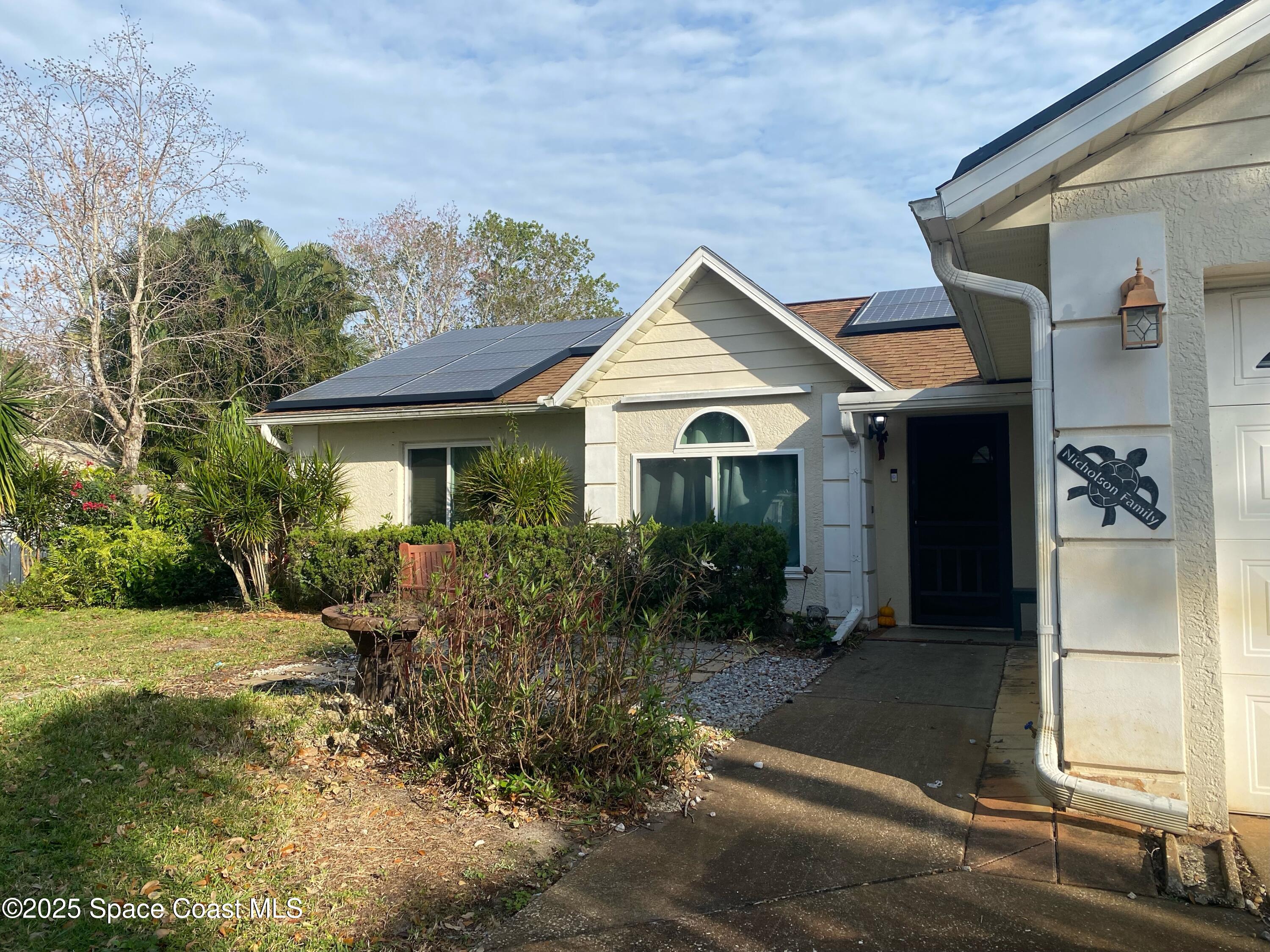 906 Black Pine Court Rockledge, FL 32955 - Photo 3 of 27 a front view of a house with garden