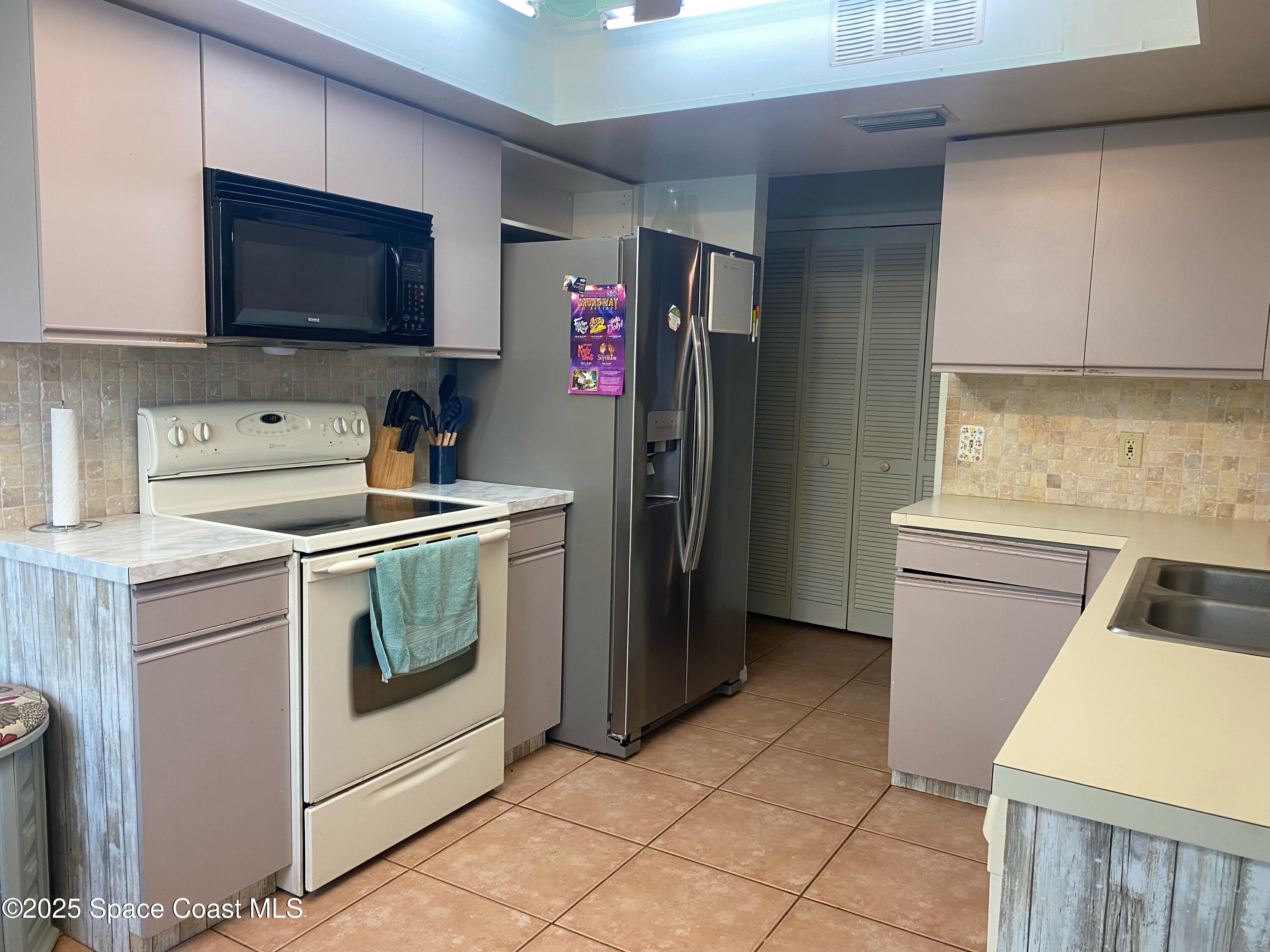 906 Black Pine Court Rockledge, FL 32955 - Photo 4 of 27 a utility room with sink dryer and washer
