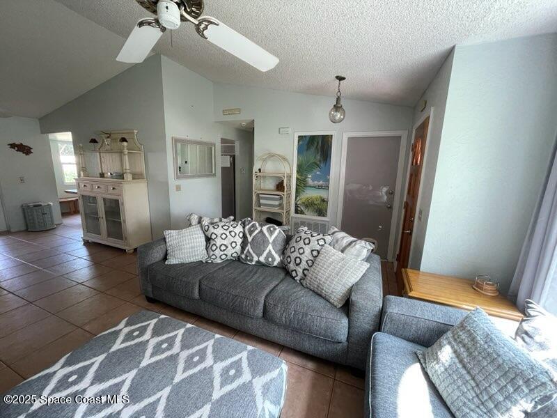906 Black Pine Court Rockledge, FL 32955 - Photo 8 of 27 a living room with furniture and a chandelier
