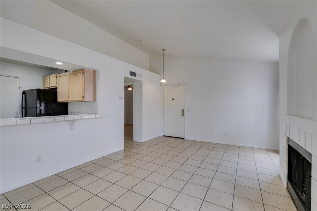 7570 West Flamingo Road, Unit 252 Las Vegas, NV 89147 - Photo 44 of 44 A versatile open floorplan featuring durable tile flooring and a cozy fireplace, perfect for daily living.