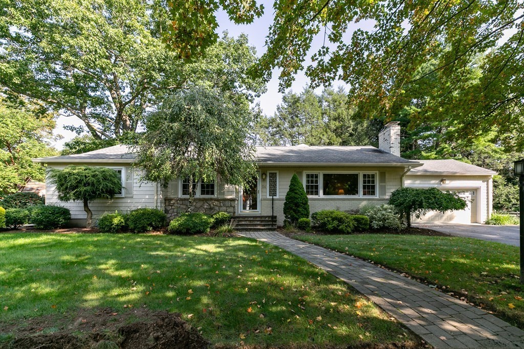 a front view of a house with a garden