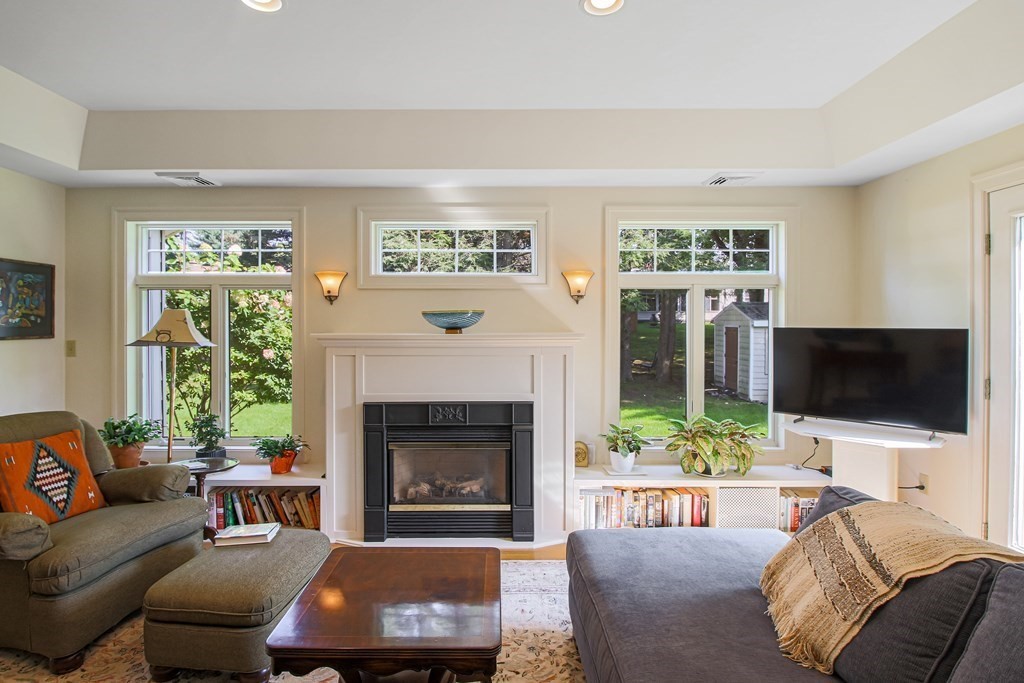 54 Ellis Drive Worcester, MA 01609 - Photo 14 of 42 a living room with furniture a fireplace and a flat screen tv