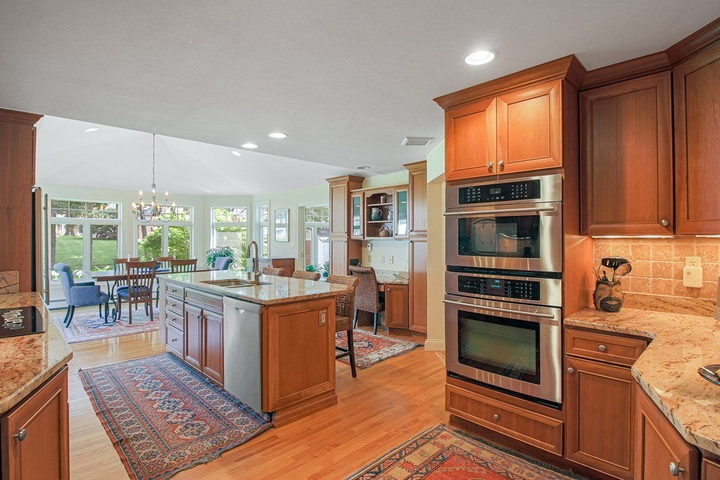 54 Ellis Drive Worcester, MA 01609 - Photo 18 of 42 a kitchen with stainless steel appliances granite countertop a stove top oven and a view of living room