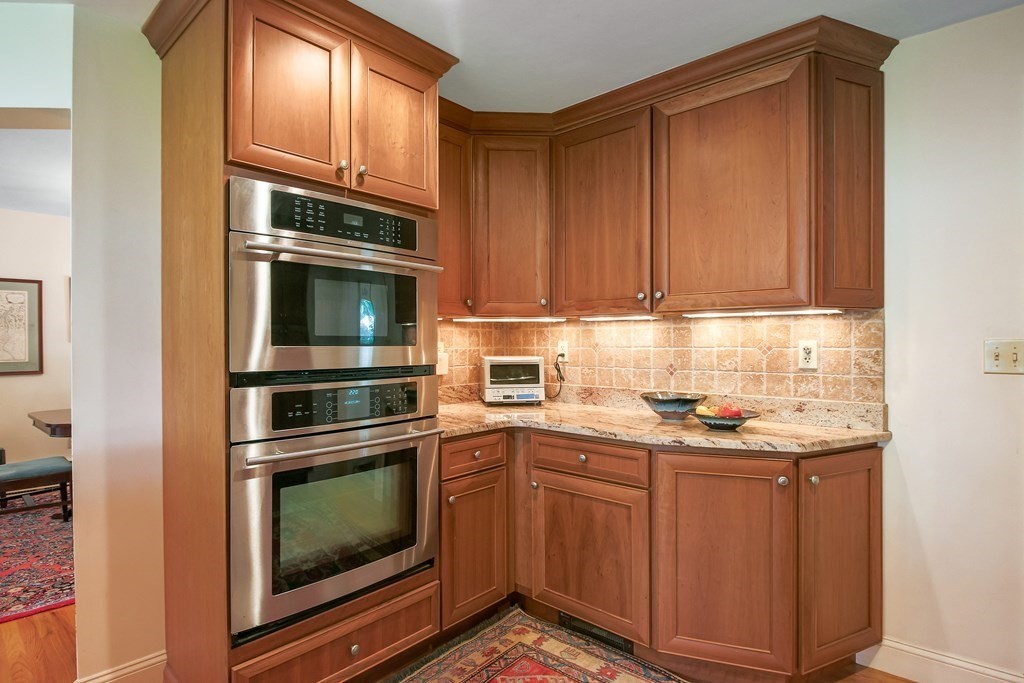 54 Ellis Drive Worcester, MA 01609 - Photo 22 of 42 a kitchen with granite countertop a stove microwave and cabinets