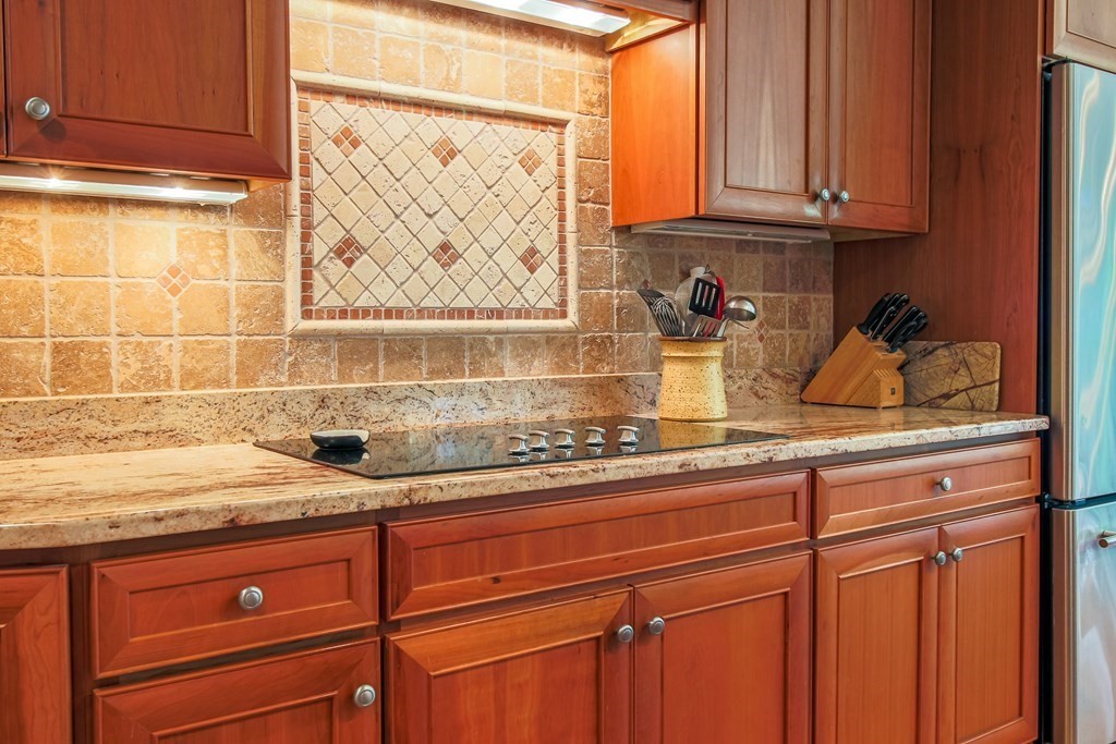 54 Ellis Drive Worcester, MA 01609 - Photo 23 of 42 a sink with granite countertop white cabinets and a window