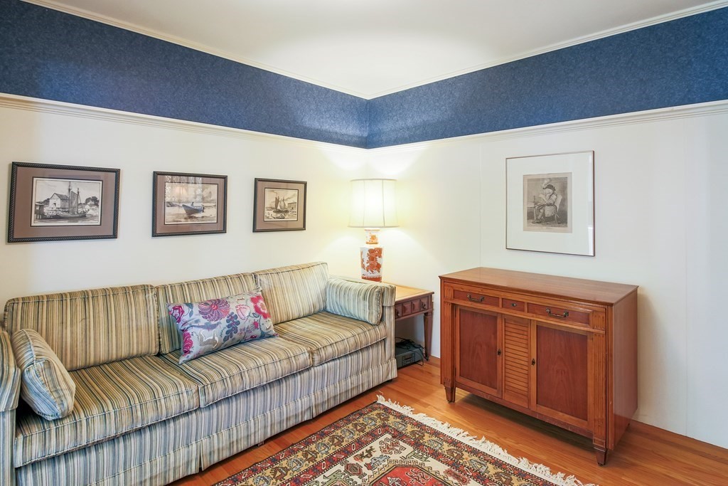 54 Ellis Drive Worcester, MA 01609 - Photo 30 of 42 a living room with furniture and a baby crib