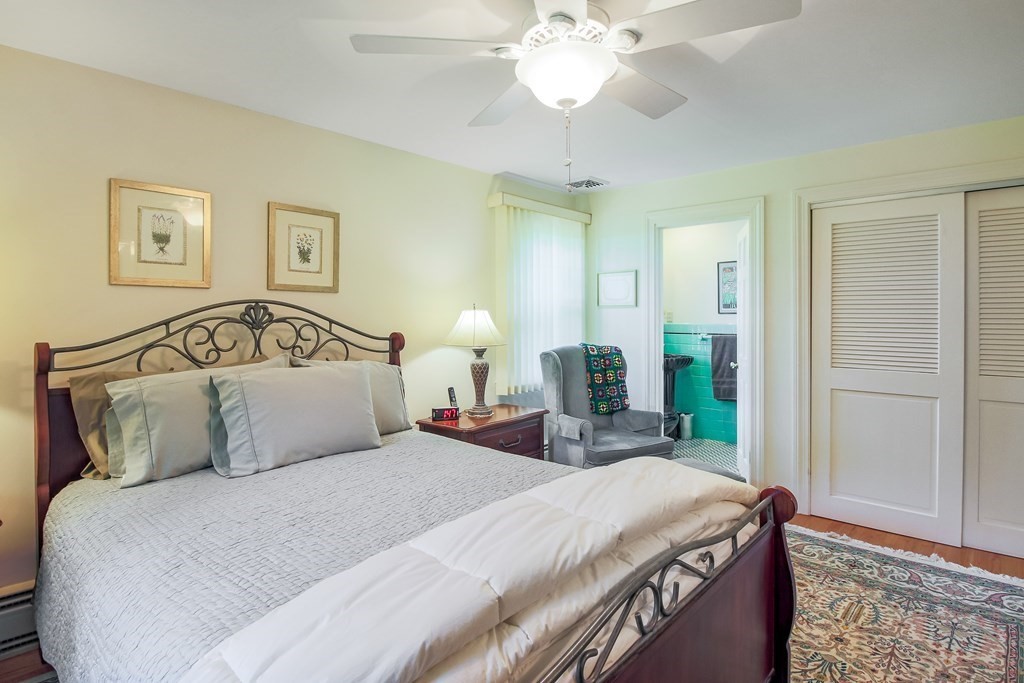 54 Ellis Drive Worcester, MA 01609 - Photo 34 of 42 a bedroom with a bed and a chandelier