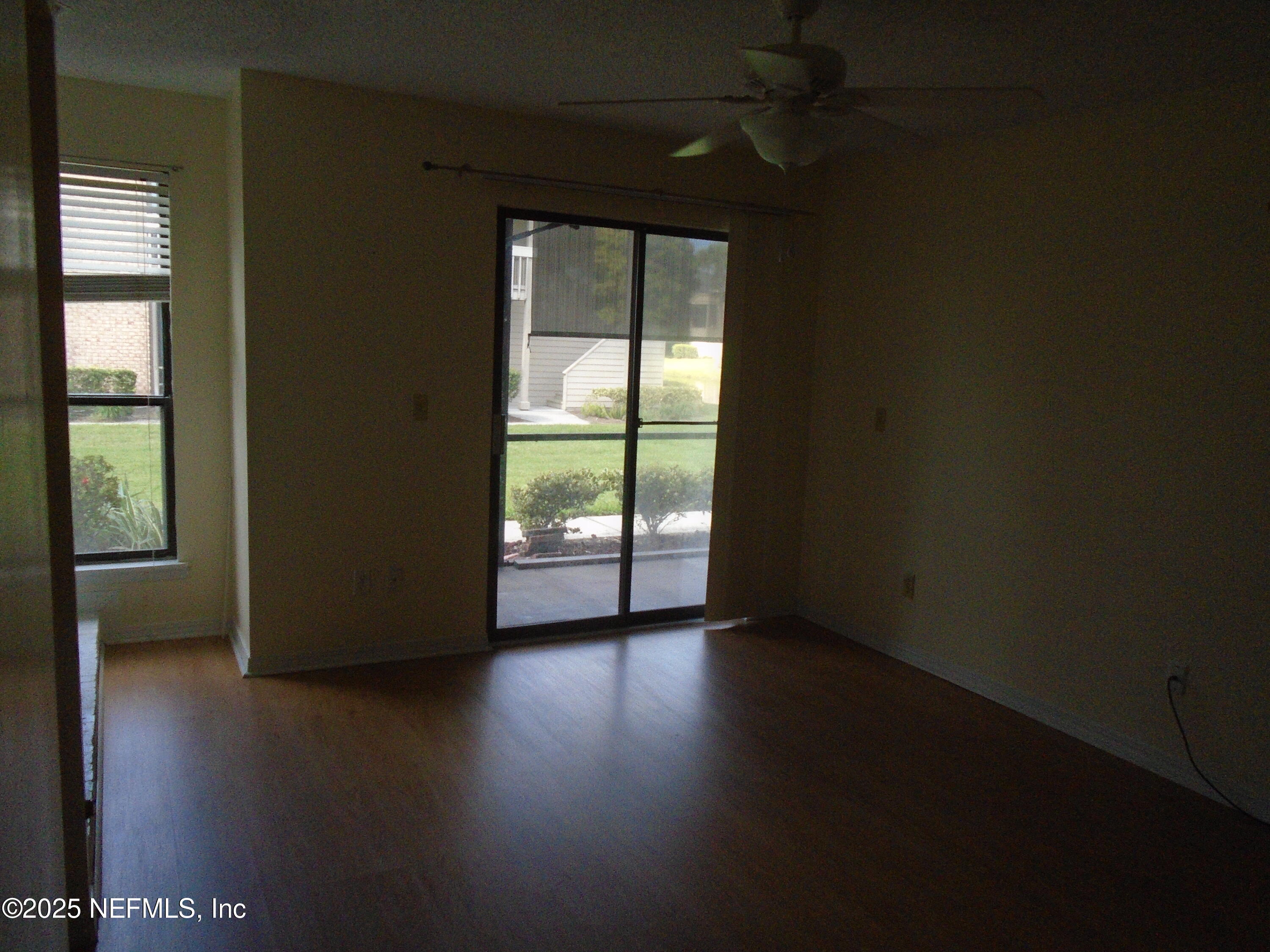10200 Belle Rive Boulevard, Unit 163 Jacksonville, FL 32256 - Photo 9 of 13 an empty room with wooden floor and windows