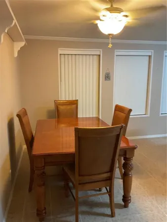 a view of a dining room with furniture and a chandelier
