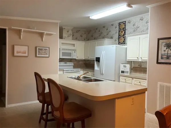 a kitchen with stainless steel appliances a refrigerator and a stove top oven