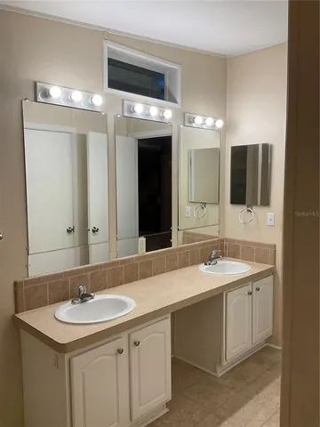 a bathroom with a sink toilet a mirror and shower curtain