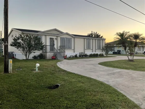 a view of a house with a backyard