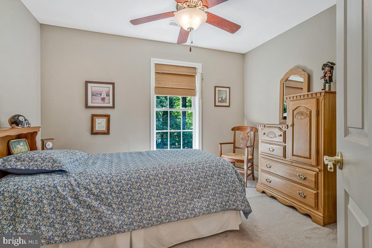 11565 Magnolia Court Issue, MD 20645 - Photo 34 of 68 a bedroom with a bed and a chandelier