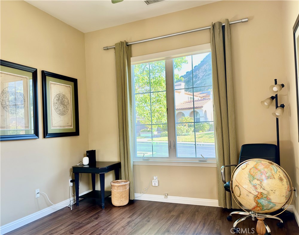 20318 West Vía Urbino Porter Ranch, CA 91326 - Photo 12 of 34 a view of a livingroom with wooden floor and a window