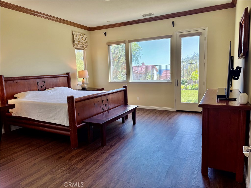 20318 West Vía Urbino Porter Ranch, CA 91326 - Photo 15 of 34 a bedroom with a bed and wooden floor