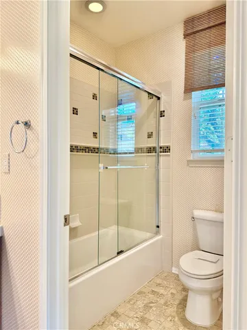 a bathroom with a shower and a toilet