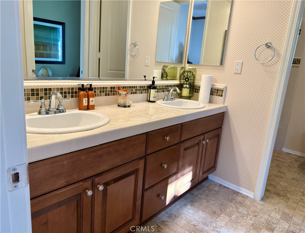 20318 West Vía Urbino Porter Ranch, CA 91326 - Photo 18 of 34 a bathroom with a double vanity sink mirror and