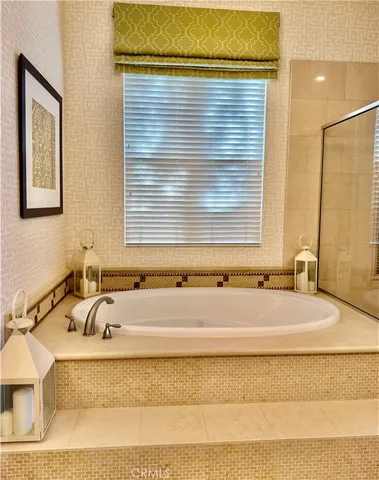 a bathroom with bathtub and window
