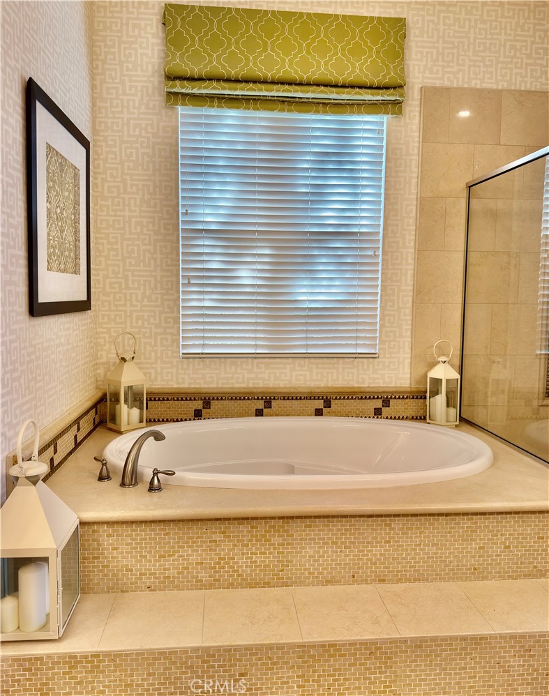 20318 West Vía Urbino Porter Ranch, CA 91326 - Photo 21 of 34 a bathroom with bathtub and window