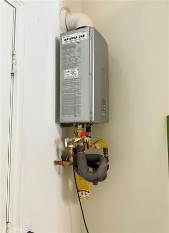 a view of a patio with table and chairs potted plants and floor to ceiling window