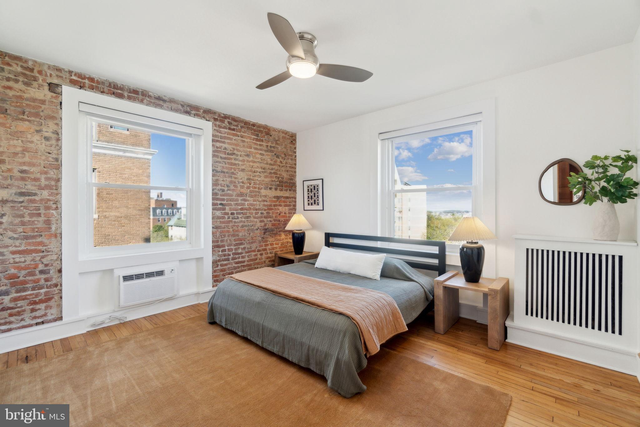 1901 Columbia Road Northwest, Unit 805 Washington, DC 20009 - Photo 15 of 37 a bedroom with a bed and a window