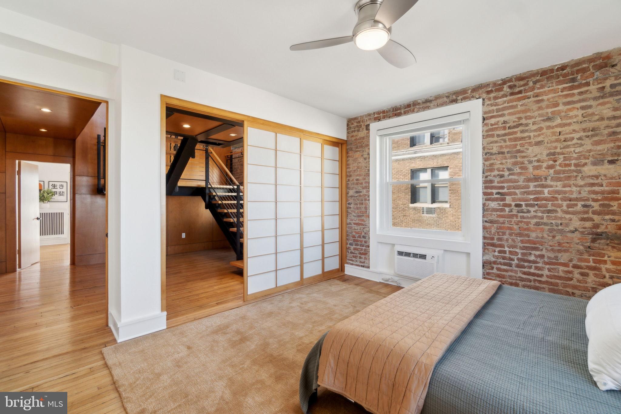 1901 Columbia Road Northwest, Unit 805 Washington, DC 20009 - Photo 17 of 37 a bedroom with a bed and a chandelier