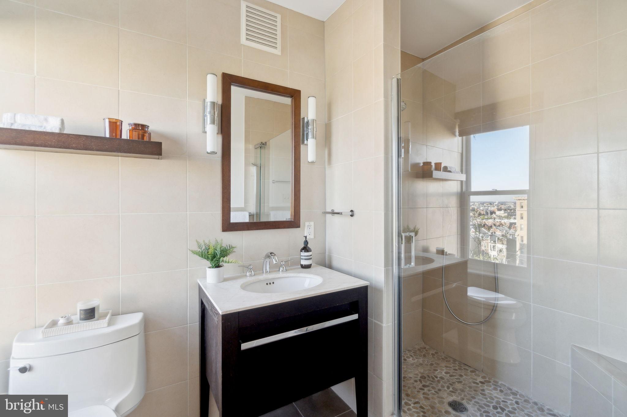 1901 Columbia Road Northwest, Unit 805 Washington, DC 20009 - Photo 18 of 37 a bathroom with a sink and a mirror
