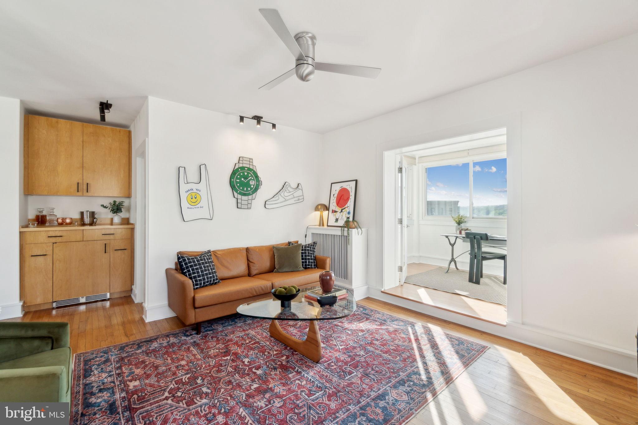 1901 Columbia Road Northwest, Unit 805 Washington, DC 20009 - Photo 4 of 37 a living room with furniture and wooden floor