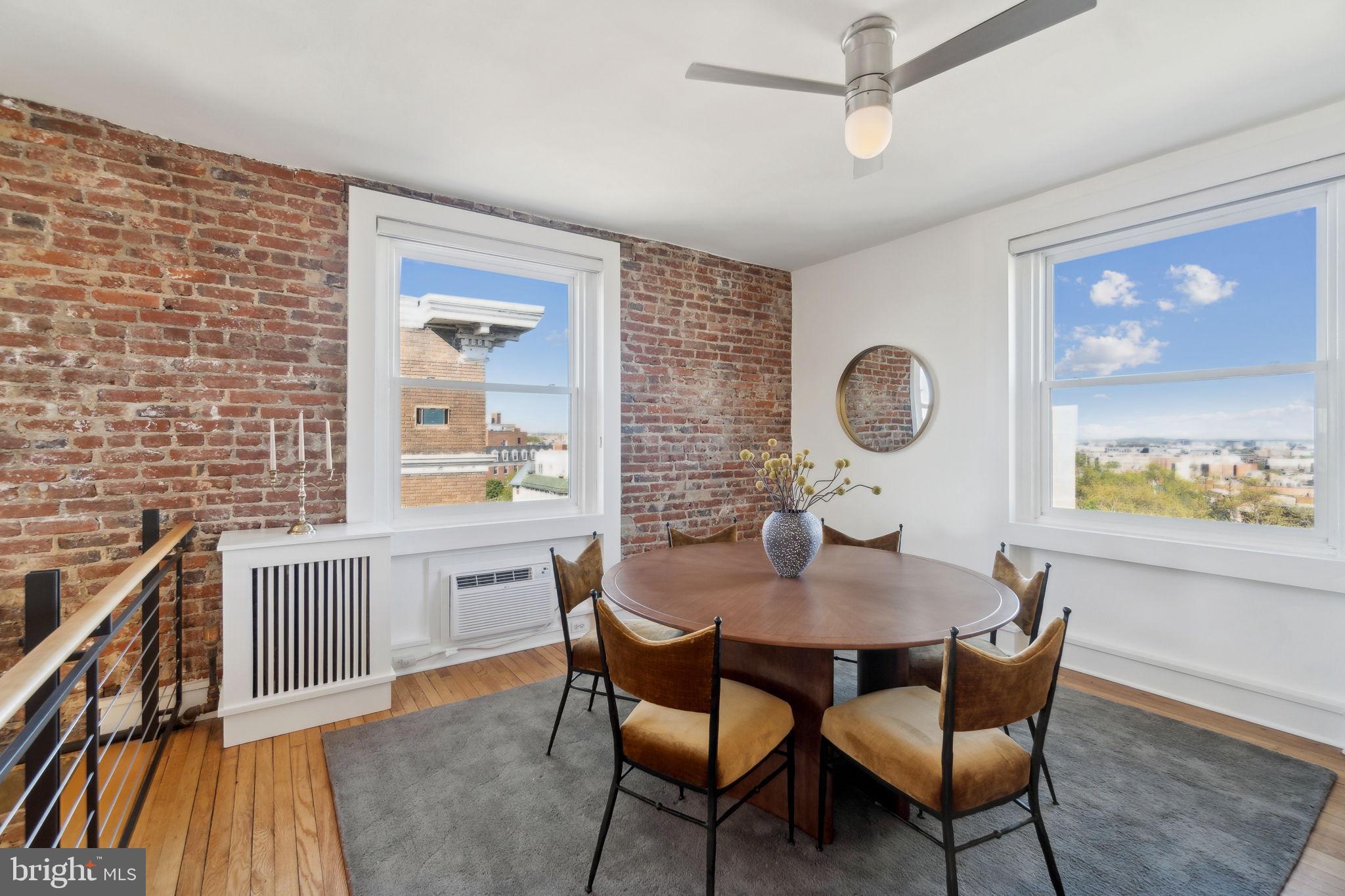 1901 Columbia Road Northwest, Unit 805 Washington, DC 20009 - Photo 9 of 37 a dining room with furniture a window and wooden floor