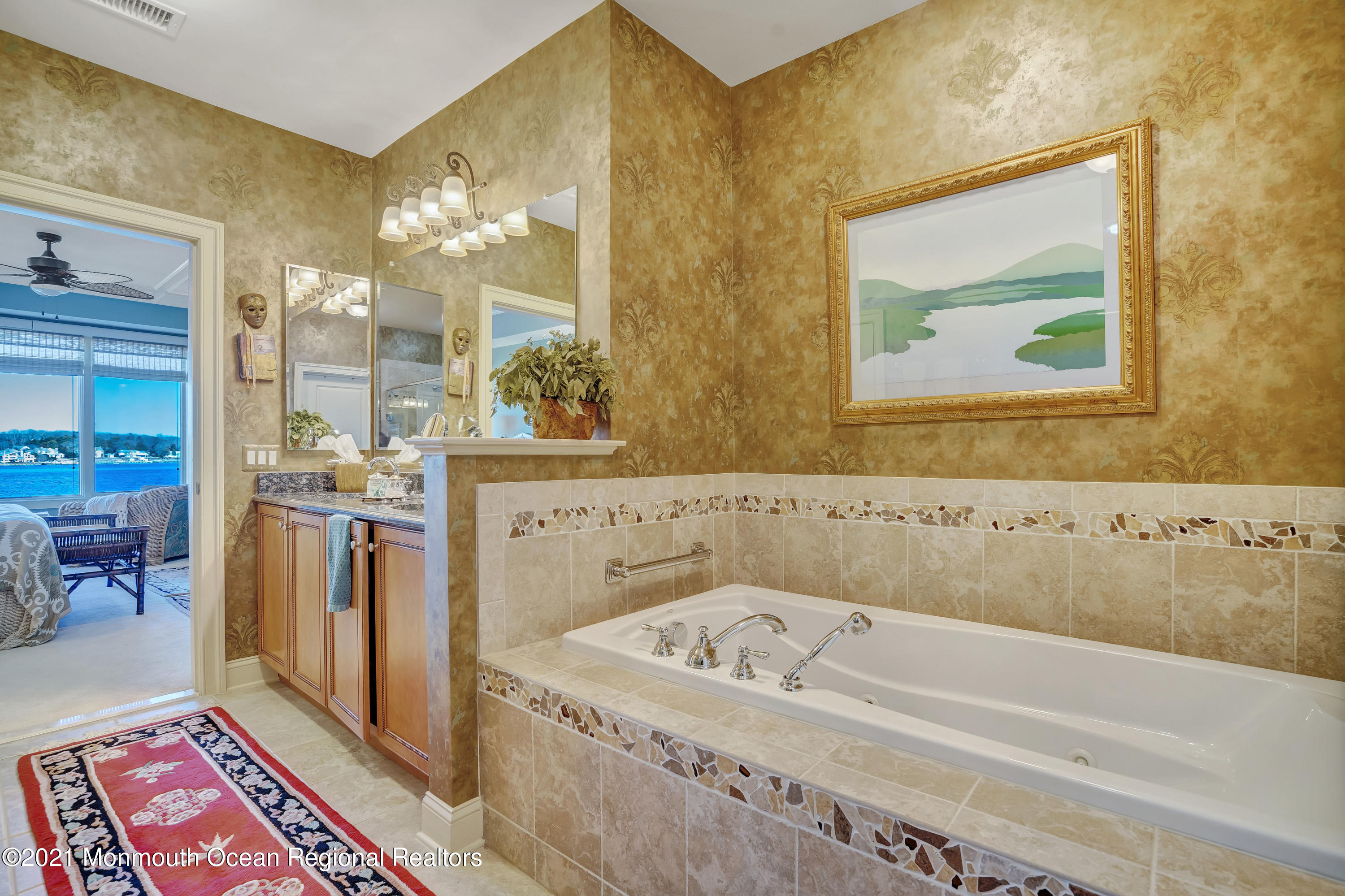 2201 River Road, Unit 3202 Point Pleasant, NJ 08742 - Photo 20 of 44 a bathroom with a tub a sink and a mirror
