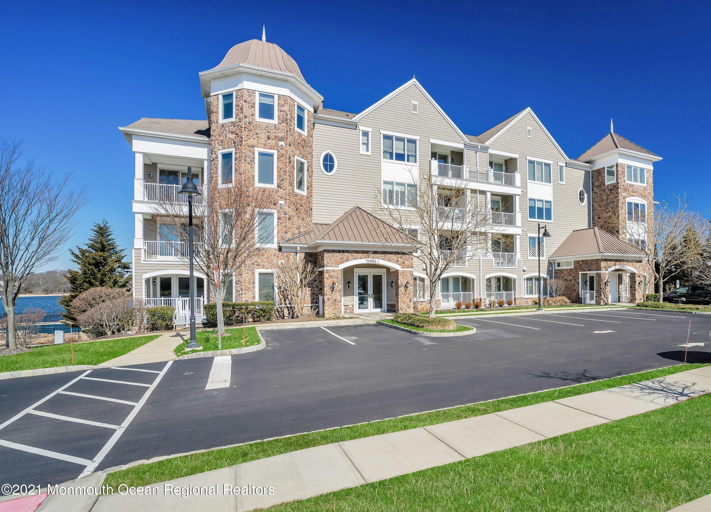 2201 River Road, Unit 3202 Point Pleasant, NJ 08742 - Photo 3 of 44 a front view of a building with a yard