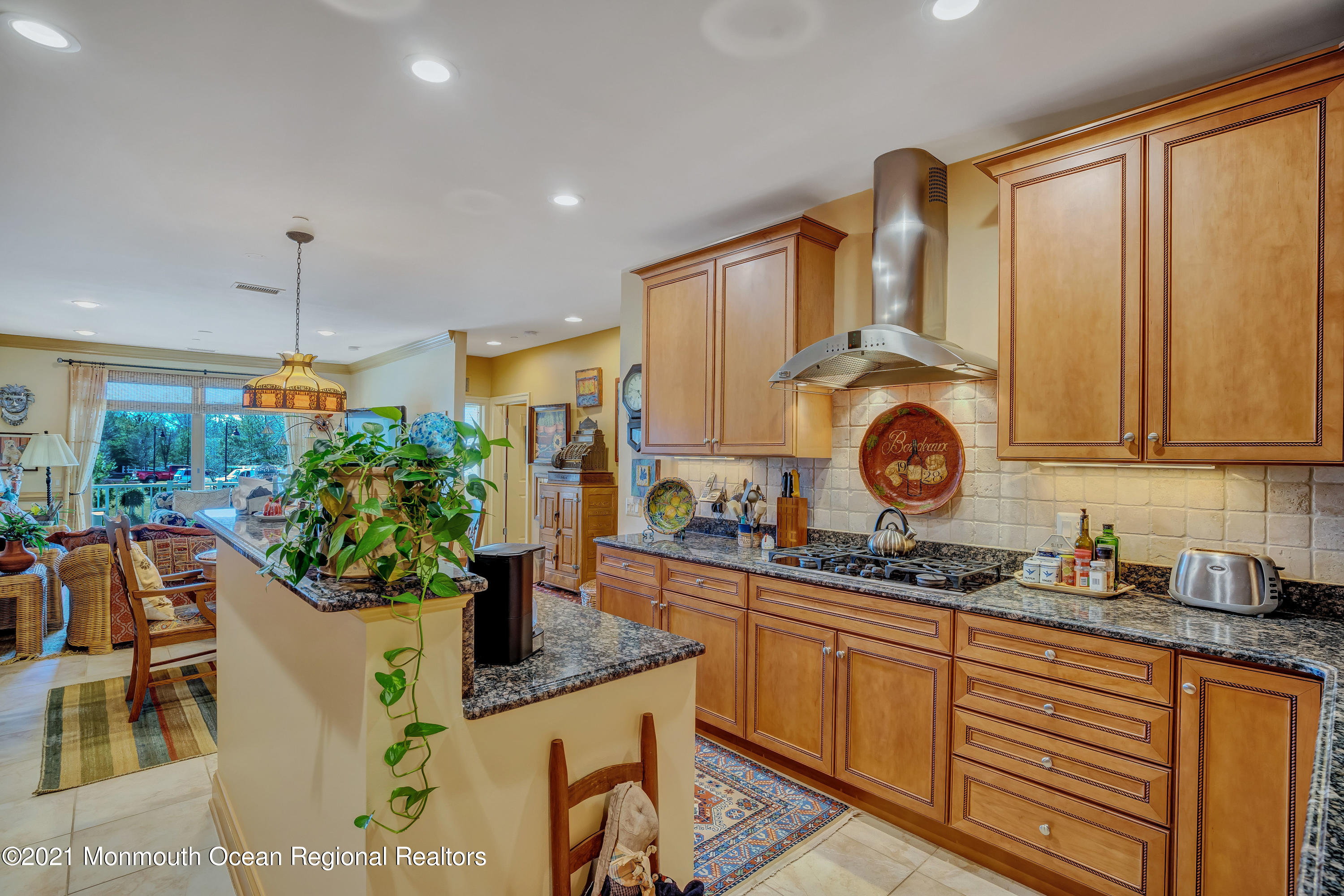 2201 River Road, Unit 3202 Point Pleasant, NJ 08742 - Photo 24 of 44 a kitchen with stainless steel appliances granite countertop a stove a sink a microwave and dining table