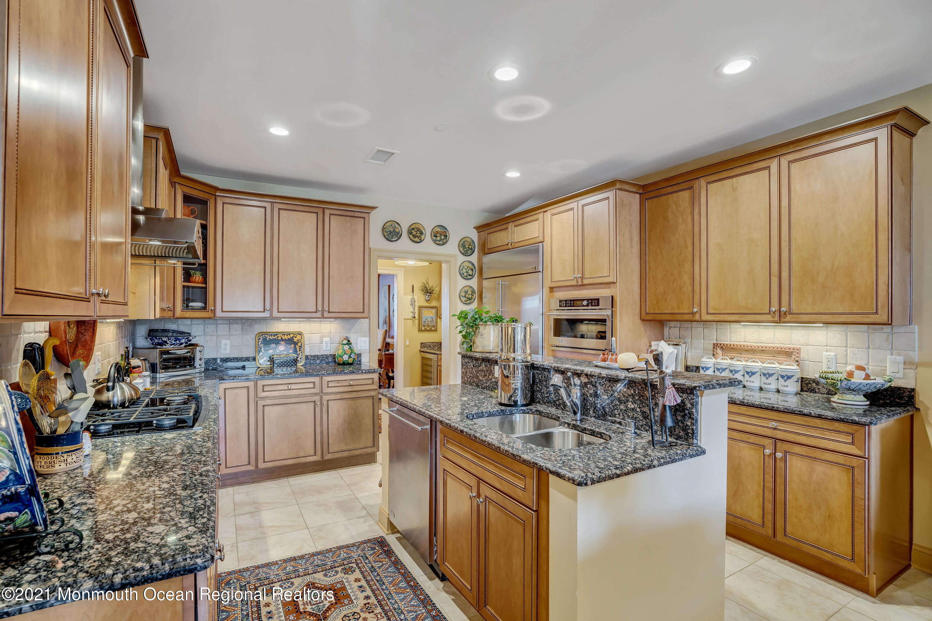 2201 River Road, Unit 3202 Point Pleasant, NJ 08742 - Photo 26 of 44 a kitchen with stainless steel appliances granite countertop a stove top oven a sink and dishwasher a oven with wooden cabinets