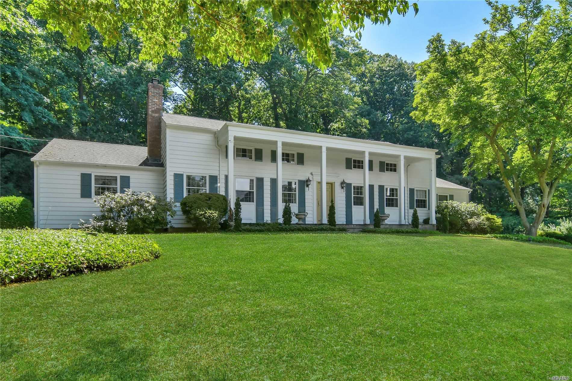 148 Factory Pond Road Mill Neck, NY 11560 - Photo 1 of 1 front view of a house with a garden