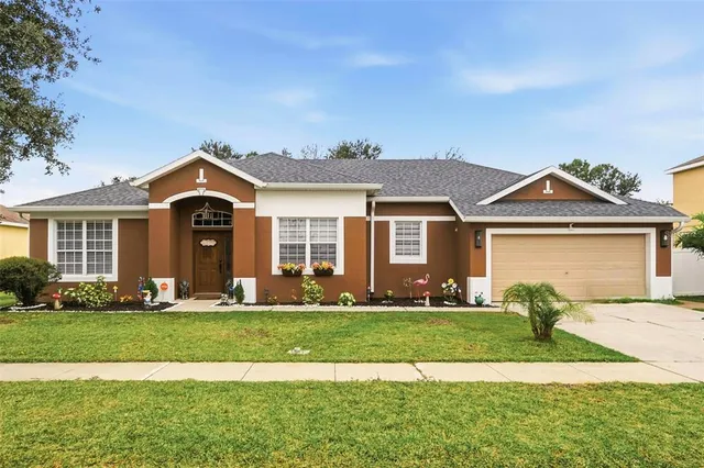 a front view of a house with a yard and garage