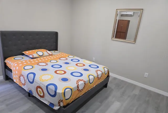 a bedroom with a bed and a window