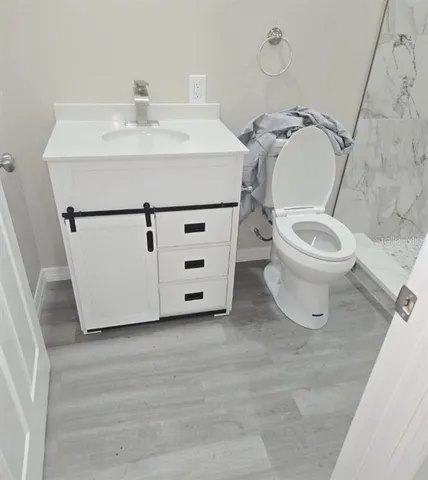 a white toilet sitting next to a bathroom sink