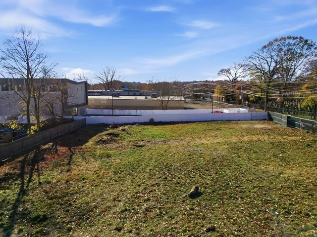 a view of a dry yard with mountains in the background