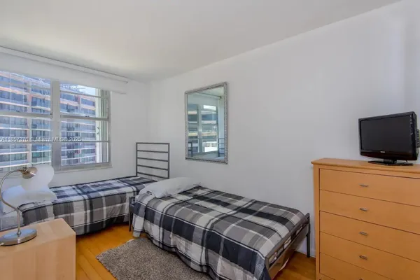 a bedroom with a bed and a tv