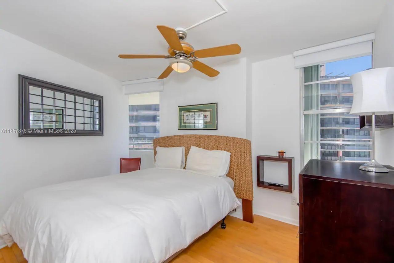 5161 Collins Avenue, Unit 1104 Miami Beach, FL 33140 - Photo 13 of 19 a bedroom with a bed and a cabinets