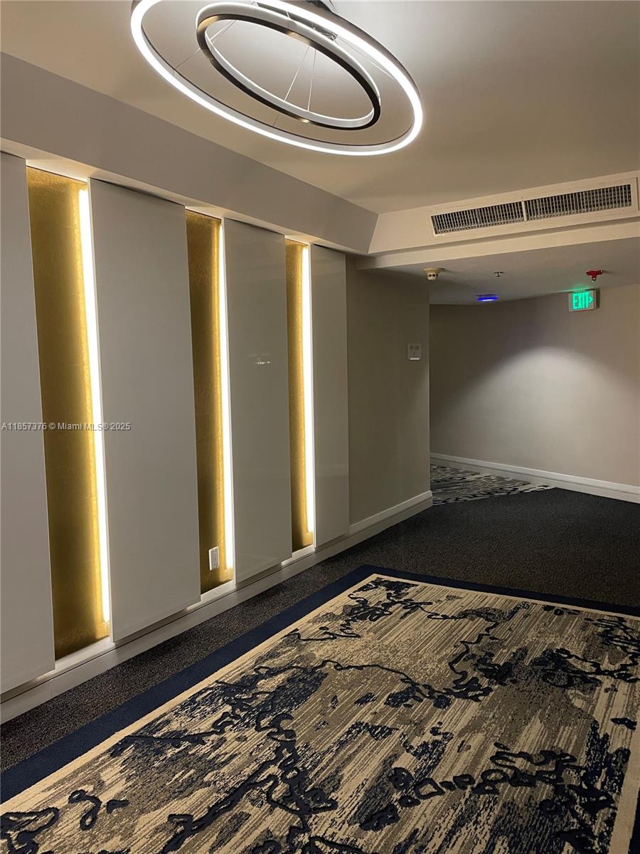 5161 Collins Avenue, Unit 1104 Miami Beach, FL 33140 - Photo 16 of 19 a bedroom with a bed and wooden floor