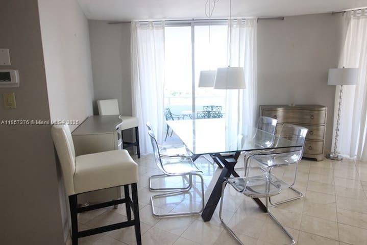 5161 Collins Avenue, Unit 1104 Miami Beach, FL 33140 - Photo 5 of 19 a work room with furniture and a large window