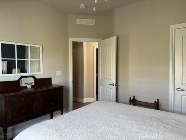 a bedroom with a bed and a dresser