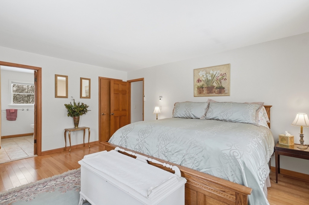 459 North Street Georgetown, MA 01833 - Photo 16 of 42 a spacious bedroom with a bed and a wooden floor