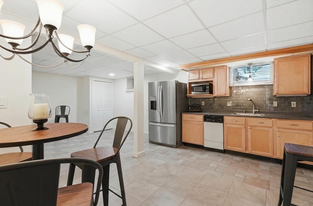 459 North Street Georgetown, MA 01833 - Photo 34 of 42 a kitchen with stainless steel appliances granite countertop a sink a stove a microwave cabinets and dining table