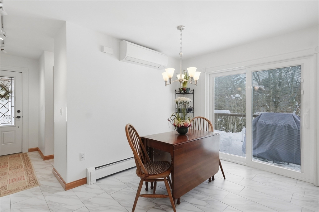 459 North Street Georgetown, MA 01833 - Photo 35 of 42 a dining room with furniture a chandelier and wooden floor