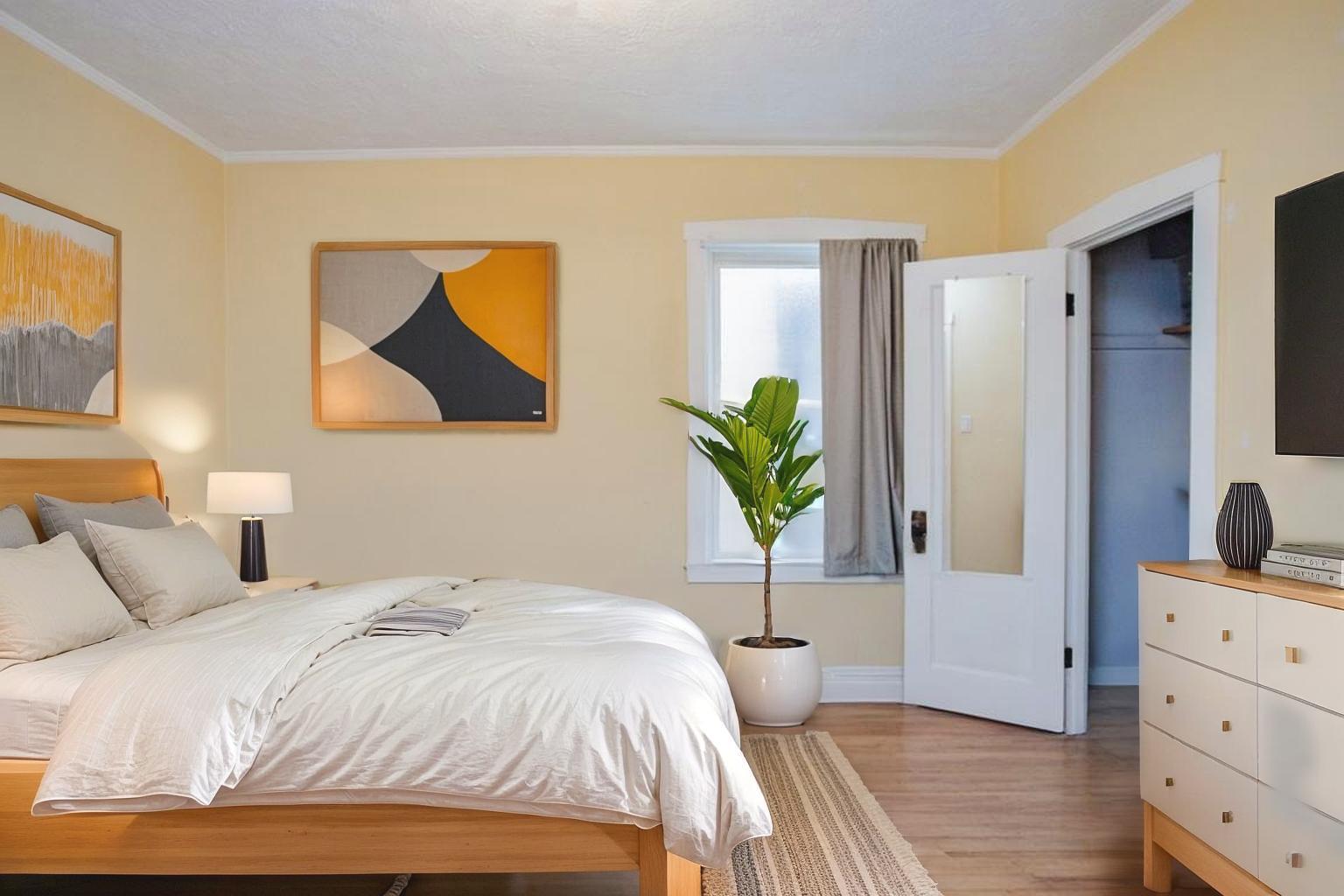2453 North Tripp Avenue Chicago, IL 60639 - Photo 11 of 17 a bedroom with a bed and a potted plant