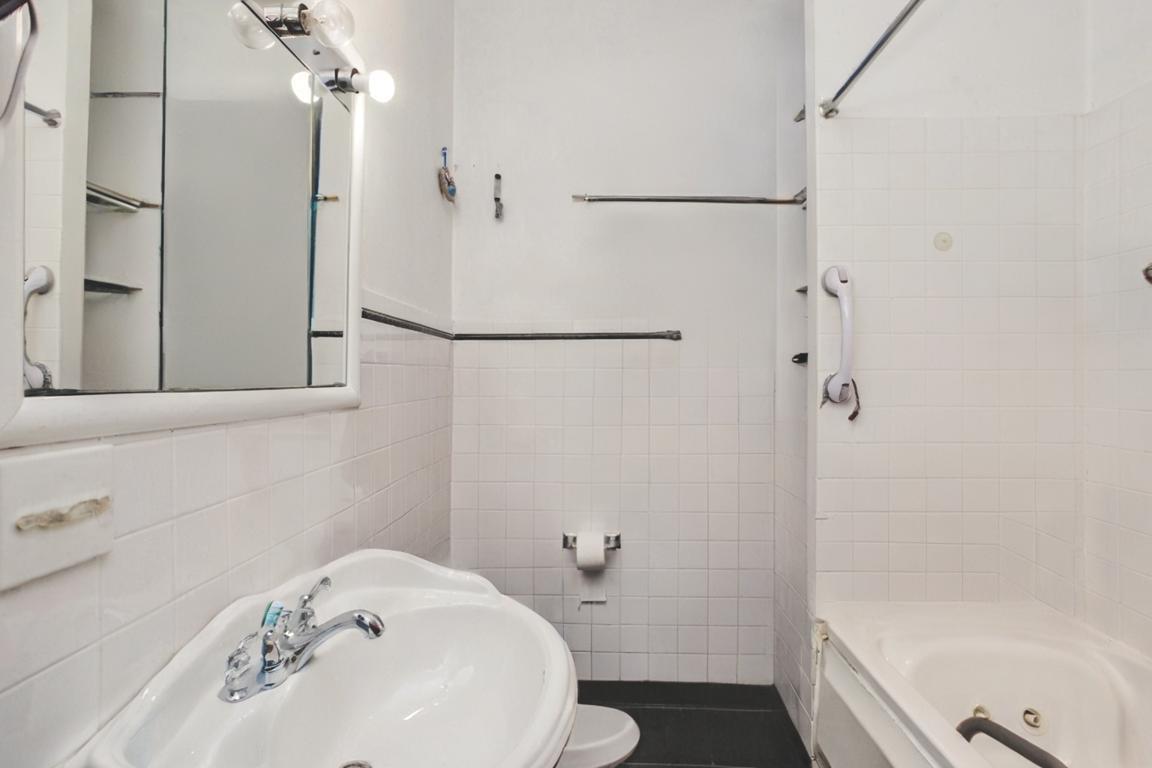 2453 North Tripp Avenue Chicago, IL 60639 - Photo 12 of 17 a bathroom with a bathtub and a shower