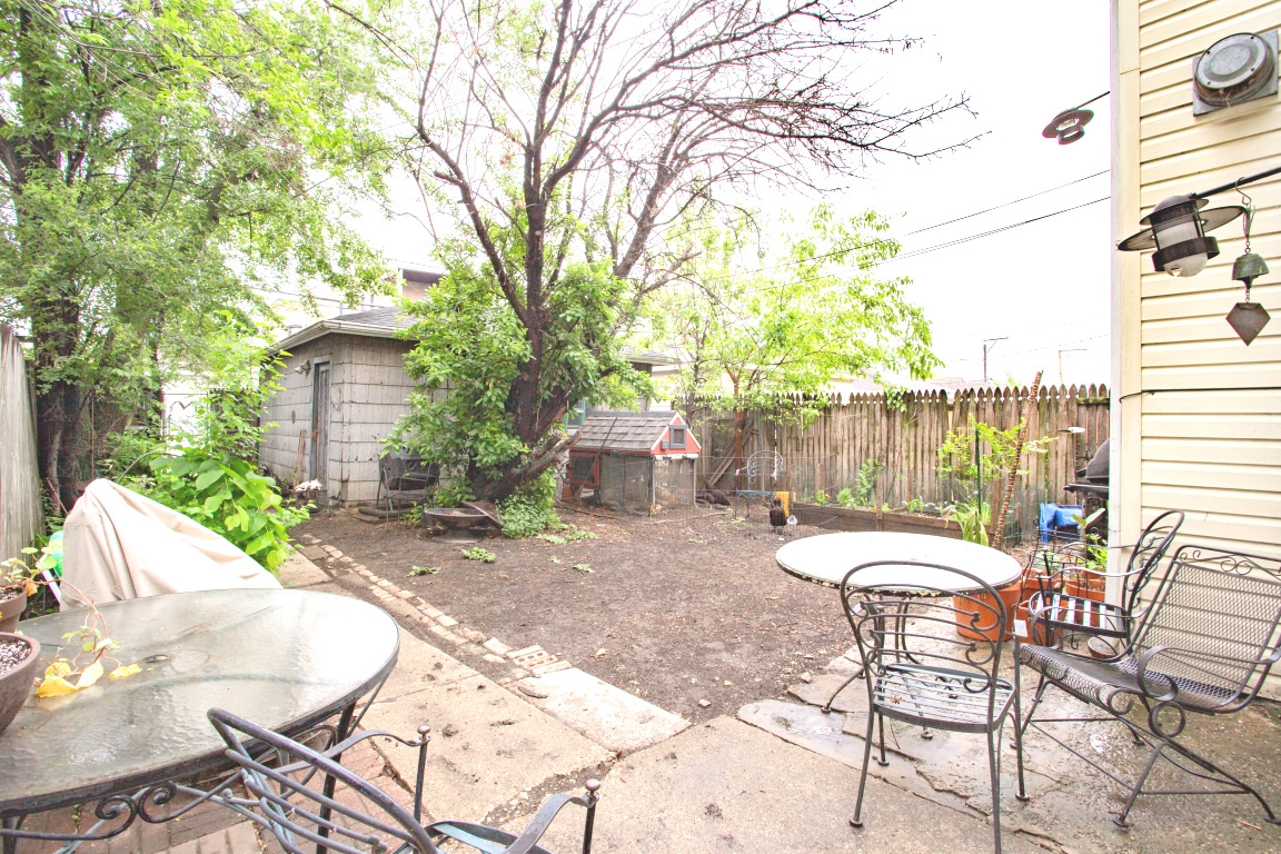 2453 North Tripp Avenue Chicago, IL 60639 - Photo 2 of 17 a view of a chairs and table in backyard