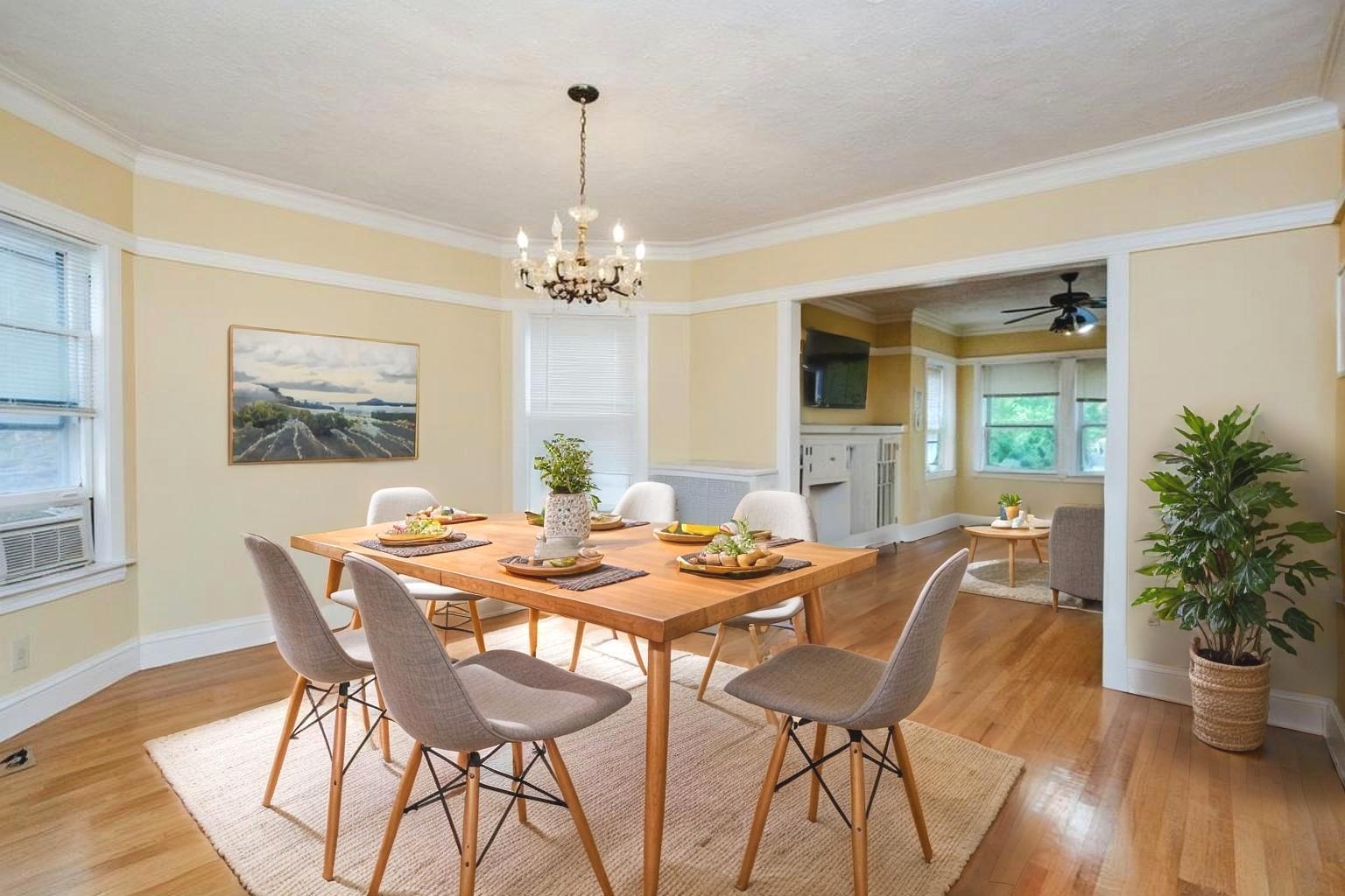 2453 North Tripp Avenue Chicago, IL 60639 - Photo 6 of 17 a view of a dining room with furniture wooden floor and chandelier